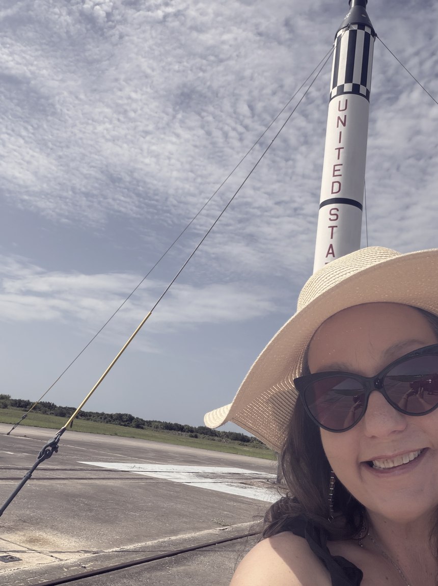 Meagan Crawford beside a Redstone rocket on a launch apron.